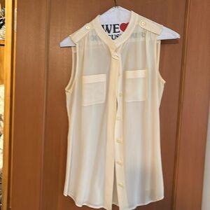 Cream sleeveless button-down blouse